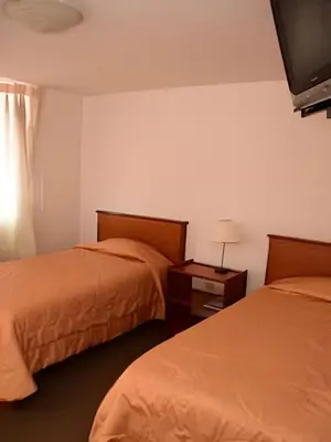 a hotel room with two beds and a television at Incasol Tower 