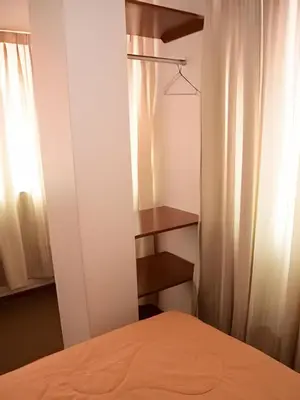 a bedroom with a bed and a curtain at Incasol Tower 