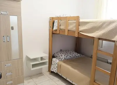 a bedroom with two bunk beds and a mirror at Departamento Pisco - San Andrés, cerca a Paracas in Gallinazos Hacienda