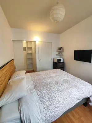 a bedroom with a large bed and a flat screen tv at Cómoda habitación independiente in Lima