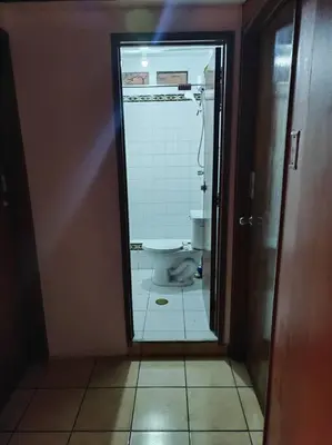 a bathroom with a toilet through a glass door at Cómoda habitación independiente in Lima