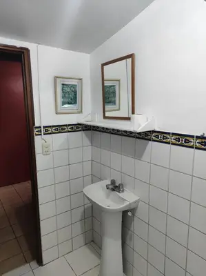 a white bathroom with a sink and a mirror at Cómoda habitación independiente in Lima