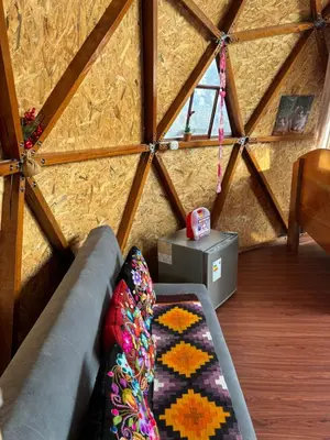 a room with a couch in a yurt at Antawara Glamping in Chipingura