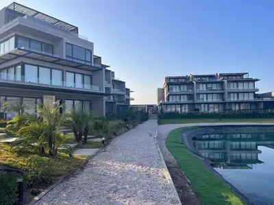 a large building next to a body of water at Aldea Bayfront Heaven Paracas in Paracas