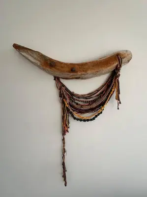 a wooden stick hanging on a white wall at Aldea Bayfront Heaven Paracas in Paracas
