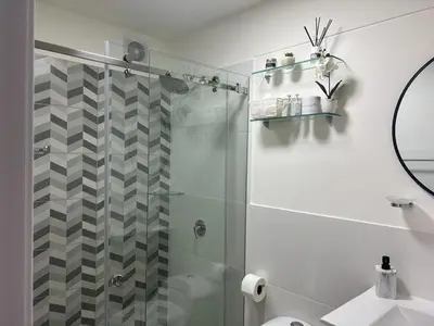 a bathroom with a shower with a glass door at Deluxe Aparment San Isidro in Lima