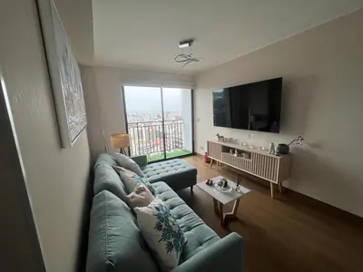 a living room with a green couch and a large window at Deluxe Aparment San Isidro in Lima