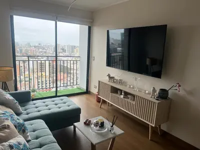 a living room with a couch and a flat screen tv at Deluxe Aparment San Isidro in Lima