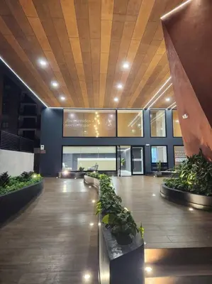 a lobby of a building with potted plants at Hermoso departamento in Lima