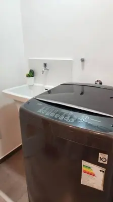 a machine in a bathroom with a sink at Hermoso departamento in Lima