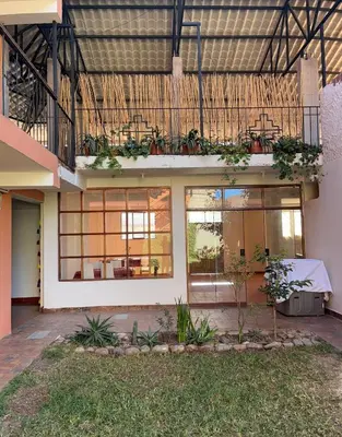 a house with a balcony with plants on it at Tambo Real Valle Sagrado in Yucay