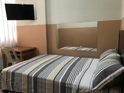 a bedroom with a bed with a mirror and a desk at Hospedaje D Francisco in Lima