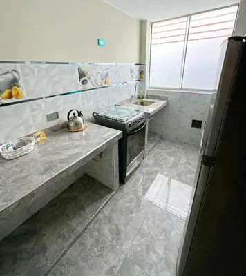 a kitchen with a stove and a sink in it at departamento airport in Lima