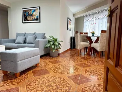 a living room with a couch and a table at departamento airport in Lima
