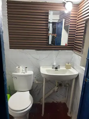 a bathroom with a white toilet and a sink at Habitación con recojo desde el aereopuerto in Cusco