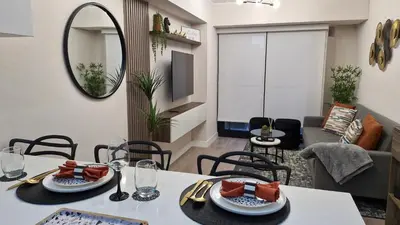a dining room with a table and a mirror at Departamento en Barranco - Like at Home in Lima