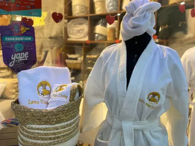 a mannequin wearing a white robe and a basket of towels at Lama Vista Living 202 in Cusco
