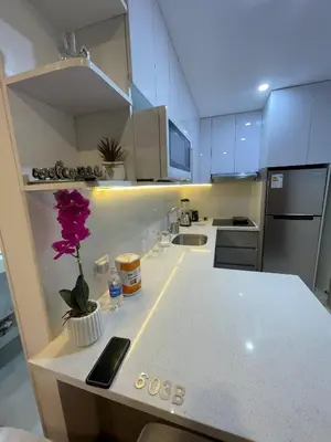 a kitchen with a white counter with a flower on it at Av arequipa 603B in Lima