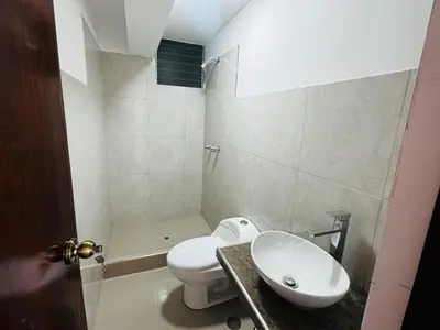a bathroom with a white toilet and a sink at Hermoso depa a 10 min del Centro de Huancayo in Huancayo