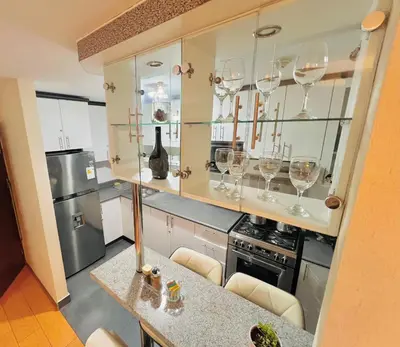 a kitchen with wine glasses on a counter at Apartamento en Santiago de Surco in Lima