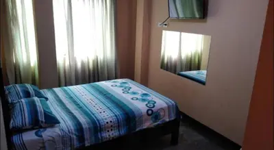 a bedroom with a bed and a mirror and a window at Francisco D Francisco in Lima