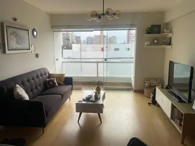 a living room with a couch and a tv at Departamento en Miraflores, Lima in Lima