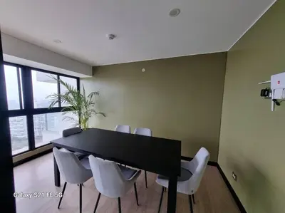 a dining room with a black table and white chairs at Moderno departamento San Isidro in Lima