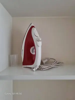 a red and white appliance sitting on a shelf at Moderno departamento San Isidro in Lima
