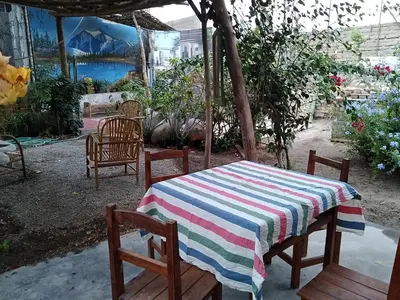 a table and chairs with a striped table cloth on it at Departamento con Cochera gratuita dentro de Instalaciones 8p Tierra del Sol Eterno Ica centro in Ica