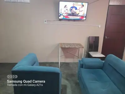 a living room with a blue couch and a tv at 201 Comfy Apt WiFi kitchen SmartTV Central at Callao in Lima