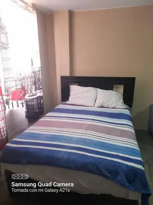 a bedroom with a bed with a striped blanket at 201 Comfy Apt WiFi kitchen SmartTV Central at Callao in Lima