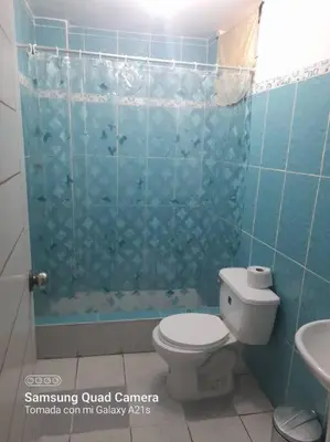 a bathroom with a toilet and a glass shower at 201 Comfy Apt WiFi kitchen SmartTV Central at Callao in Lima