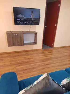 a living room with a flat screen tv on the wall at Departamento INTI - casa de Teresita in Cusco