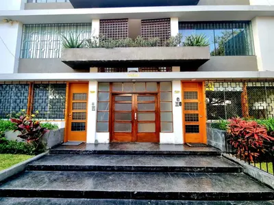 a building with orange doors and stairs in front at E SuiteTOP Tudela San Isidro Lima 2B 202 in Lima