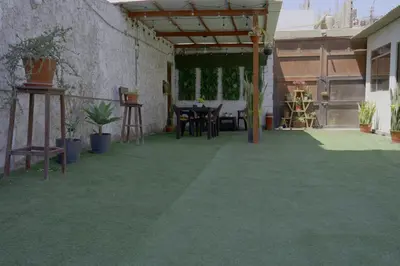 an outdoor patio with a table and chairs at Hotel San Martín in San Juan de Marcona