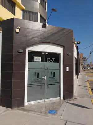 a building with two garage doors in a building at Hotel San Martín in San Juan de Marcona