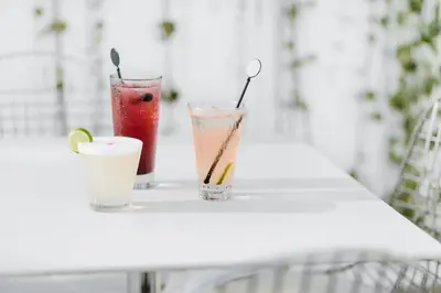 three cocktails sitting on a white table at Wyndham Costa del Sol Lima City in Lima