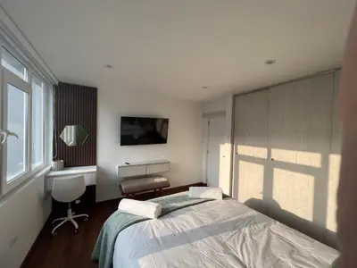 a bedroom with a bed and a desk and a window at Wonderful apartment Miraflores Kennedy 603A in Lima