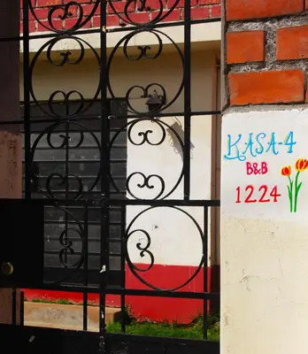 a wrought iron gate in front of a building at Kasa-4 B&B Family Home in Huancayo