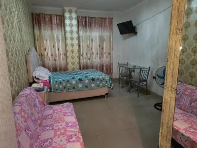 a room with two beds and a table with a tableablish at ESTUDIO COMPLETO en el CENTRO HISTORICO de LIMA in Lima