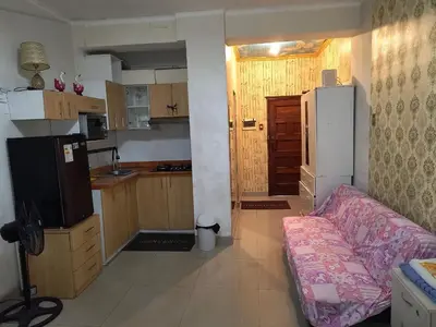 a living room with a couch and a kitchen at ESTUDIO COMPLETO en el CENTRO HISTORICO de LIMA in Lima