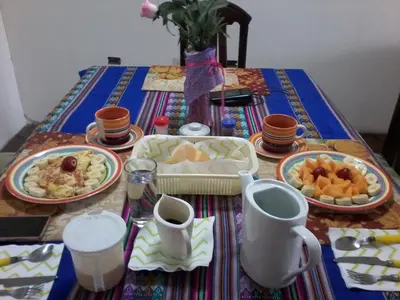 a table with plates of food on top at Royal Sweet Dreams Airport B&B in Lima