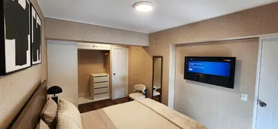 a bedroom with a bed and a flat screen tv at Hermoso Departamento Miraflores in Lima