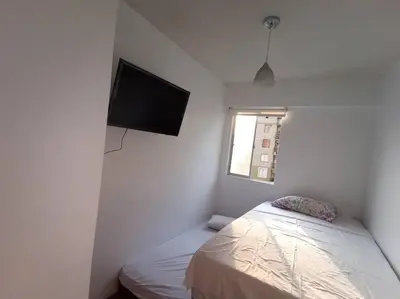 a bedroom with a bed and a flat screen tv at Departamento de 04 dormitorios in Lima