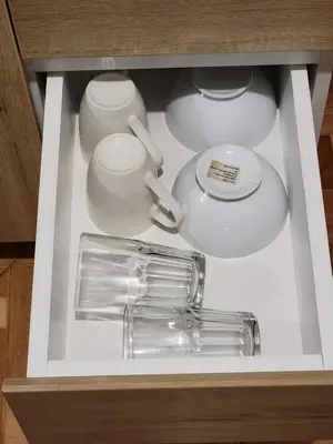 a drawer filled with dishes and a tea pot and a cup at Departamento, LUJO HOGAR cerca a PLAZA NORTE - UNI AEROPUERTO in Lima