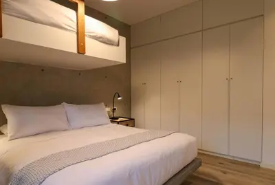 a bedroom with a large white bed with a ceiling at Aldea 3BR Chic Bay Hideaway in Paracas