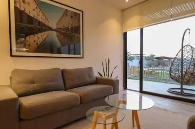 a living room with a couch and a glass table at Aldea 3BR Chic Bay Hideaway in Paracas