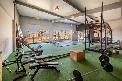 a gym with several exercise equipment in a room at 2BR Spacious Ground Level with Gym Pool and Cowork in Paracas