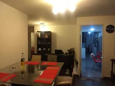 a living room with a table and a dining room at Moderno Apartamento Vista al Parque - San Borja Sur - Lima Perú in Lima