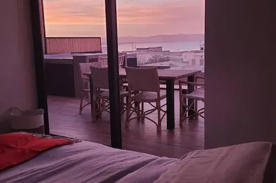 a room with a table and chairs on a balcony at Aldea 1BR Penthouse wtih Private Pool and Views for 2 in Paracas